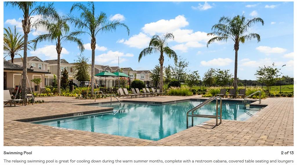 An outdoor swimming pool with lounge chairs, umbrellas, and a cabana at a residential complex — 2557 RIDER RAIN LANE, APOPKA, FL
