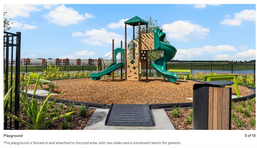 A playground with two slides, wood chip ground cover, and benches inside a fenced area — 2557 RIDER RAIN LANE, APOPKA, FL