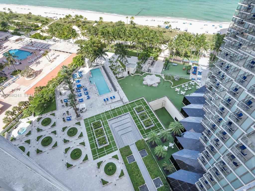 An aerial view shows a resort pool deck, landscaped gardens, and a beach — 9705 Collins Ave # 1804N, Bal Harbour FL 33154, BAL HARBOUR, FL