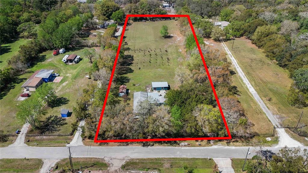 An aerial view shows a rectangular property with a house, outbuildings, and a large yard — 2700 AEIN ROAD, ORLANDO, FL