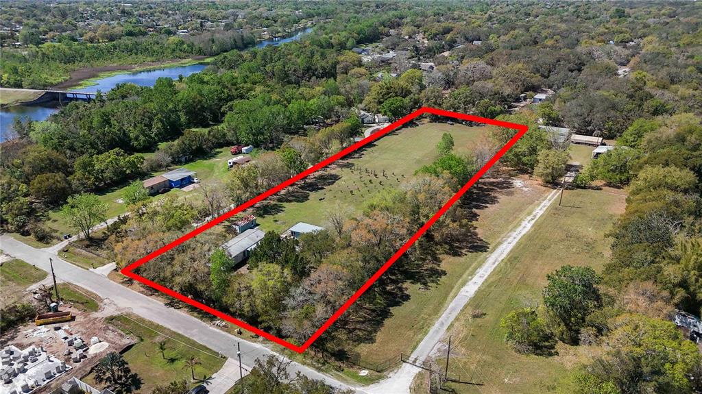 An aerial view shows a rectangular property outlined in red containing a house and trees — 2700 AEIN ROAD, ORLANDO, FL