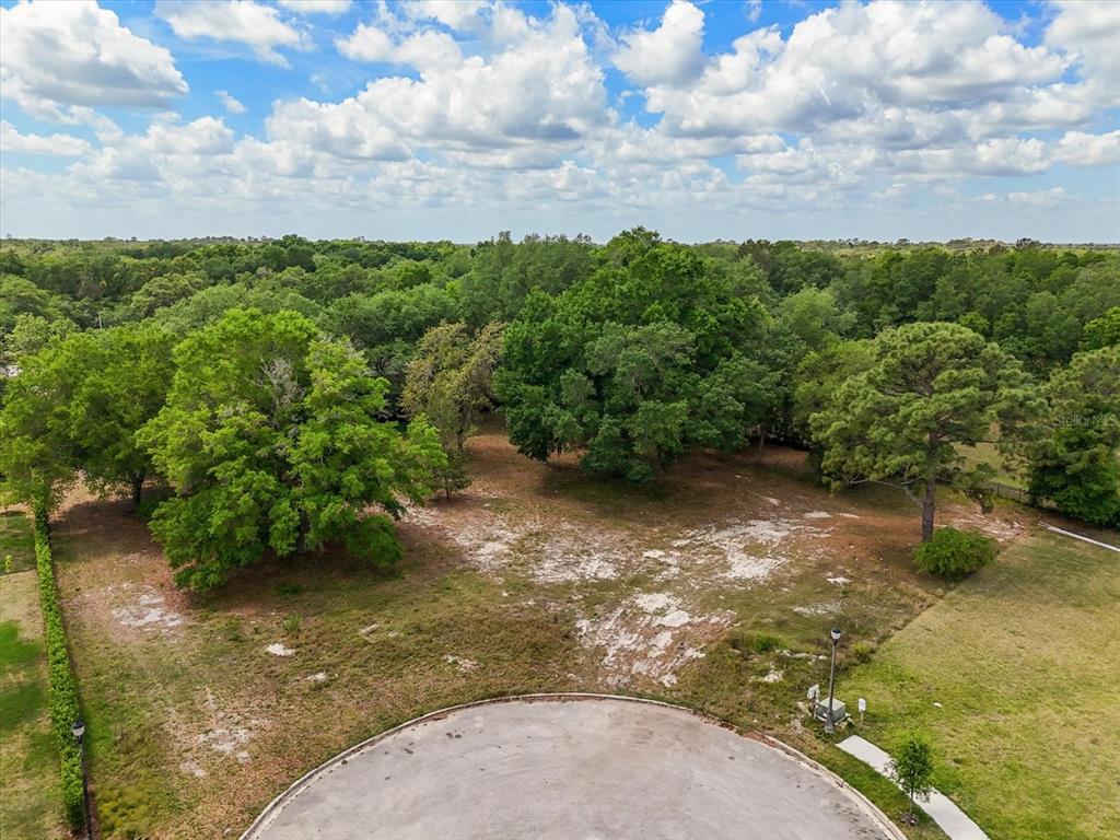 An aerial view of a vacant, partially wooded residential lot at the end of a cul-de-sac — 1657 ENCLAVE COVE, LAKE MARY, FL