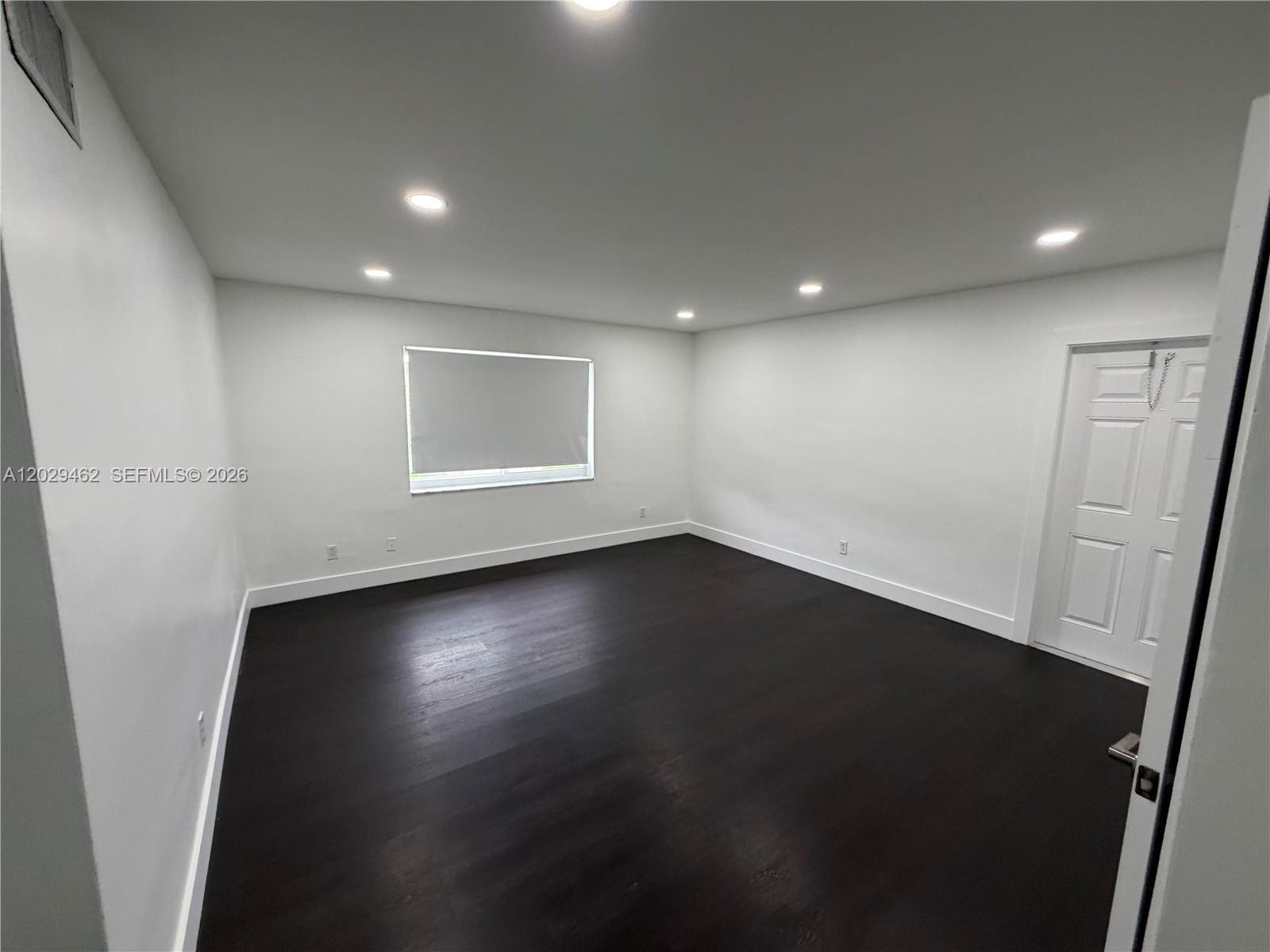 An empty room features white walls, recessed lighting, and dark wood flooring — 4850 SW 26th Ave # 4, Dania Beach FL 33312, DANIA BEACH, FL