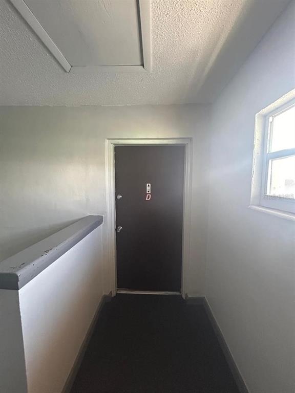 A dark door marked with the letter D sits at the end of a hallway — 1627 W OAK RIDGE ROAD UNIT D, ORLANDO, FL