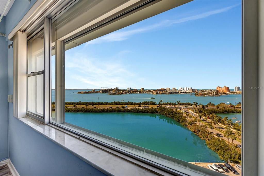 A view of a bay and city skyline from a window in a blue room — 31 ISLAND WAY UNIT 1403, CLEARWATER BEACH, FL