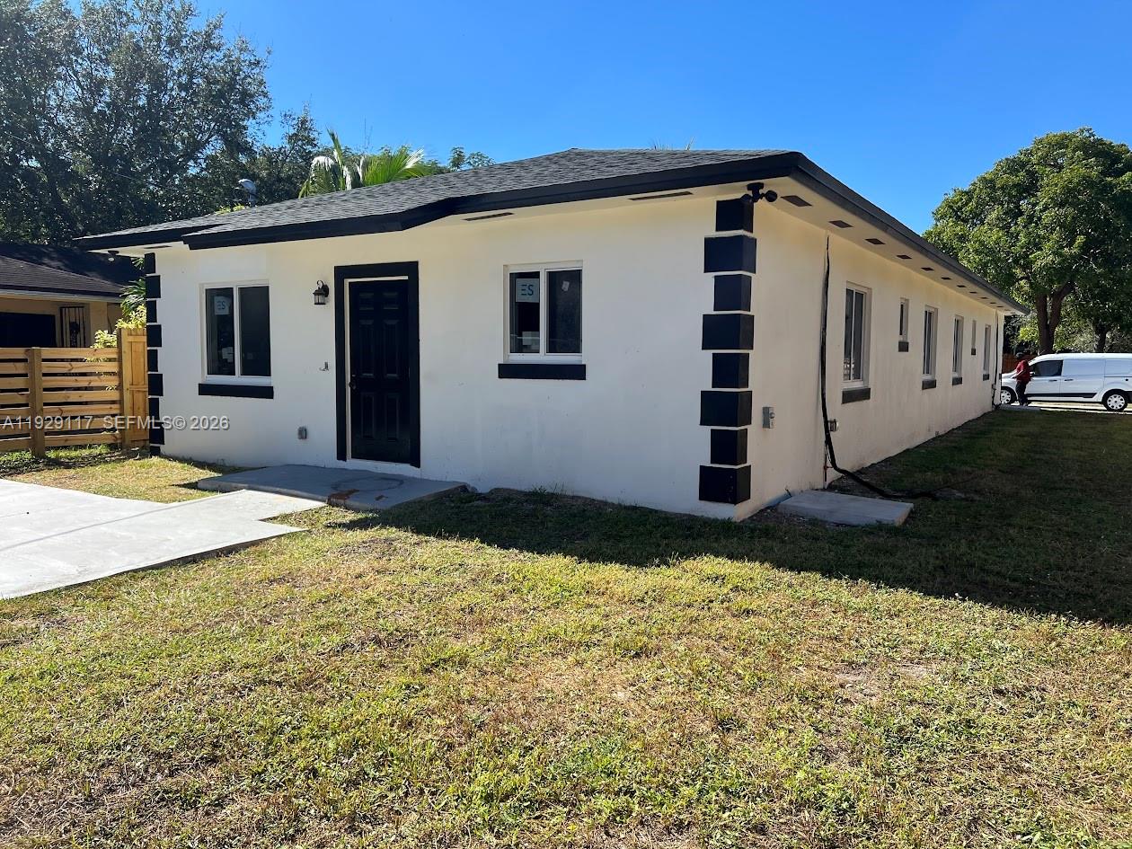 A single-story white house features black trim, a black front door, and a concrete walkway — 9254 NW 3rd Ave, Miami FL 33150, MIAMI, FL