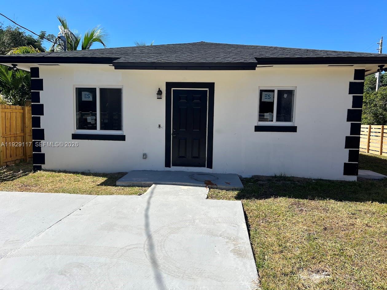 A single-story house with white stucco walls, black trim, and a black front door — 9254 NW 3rd Ave, Miami FL 33150, MIAMI, FL