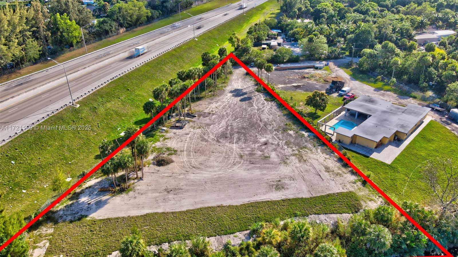 An aerial view shows a triangular vacant lot adjacent to a highway and a house — 7601 Ellen Ln, West Palm Beach FL 33411, WEST PALM BEACH, FL