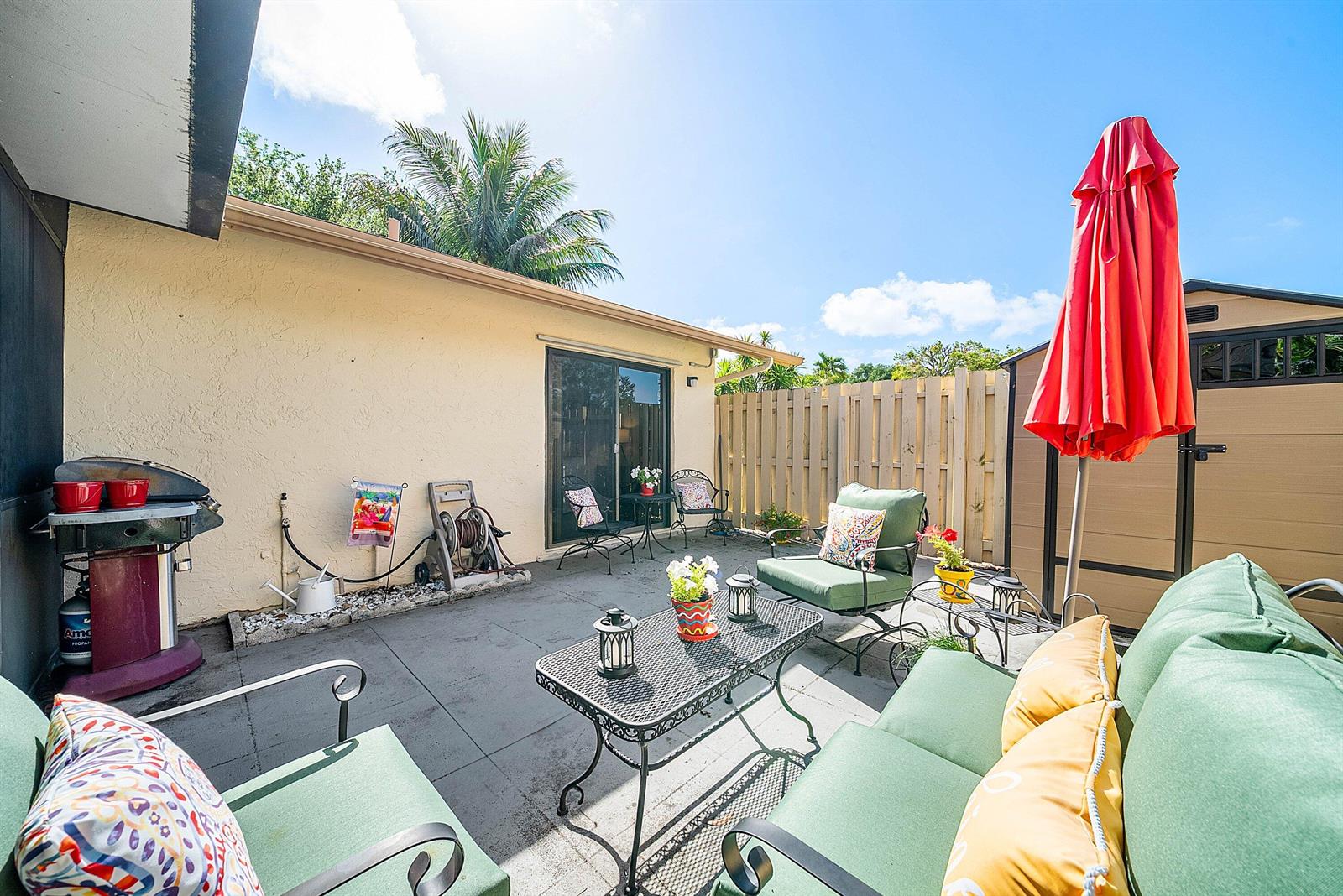 A patio features outdoor furniture, a grill, a storage shed, and a wooden fence — 777 NW 29th Avenue # A, Delray Beach FL 33445, DELRAY BEACH, FL