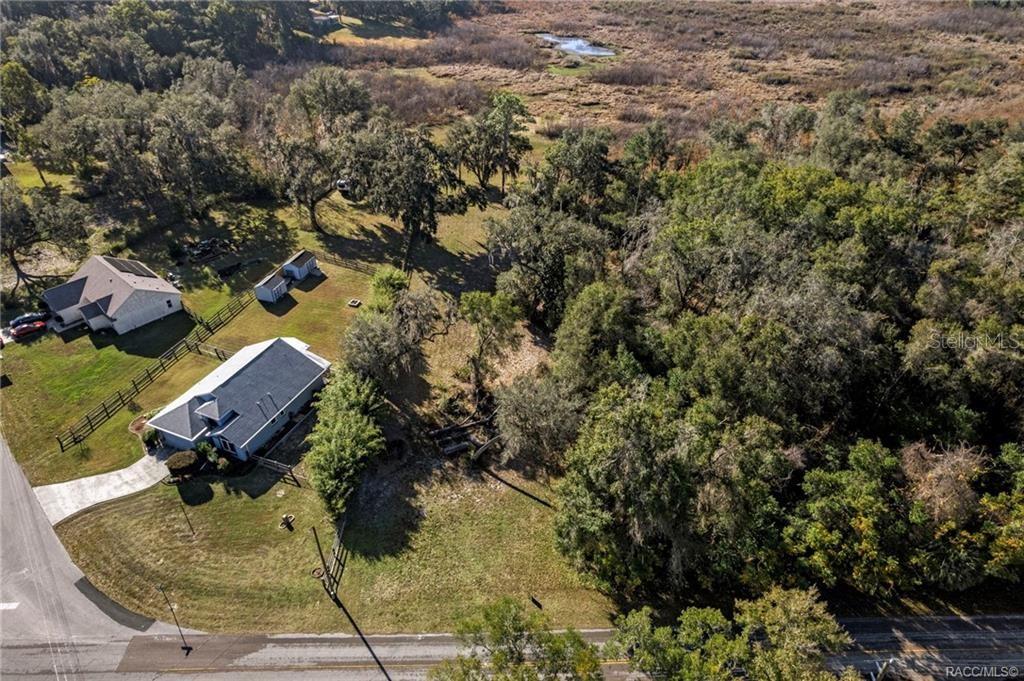 An aerial view shows a house with a detached shed on a large, wooded lot — 6616 E MALVERNE STREET, INVERNESS, FL