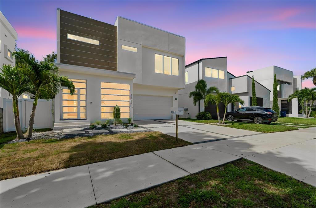 A modern white two-story house with a backyard swimming pool and a paved patio area — 1314 1/2 W. LEMON STREET, TAMPA, FL