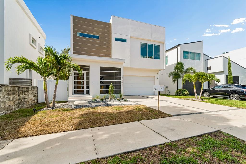 A modern two-story house with a white facade, a garage, and a palm tree — 1314 1/2 W. LEMON STREET, TAMPA, FL