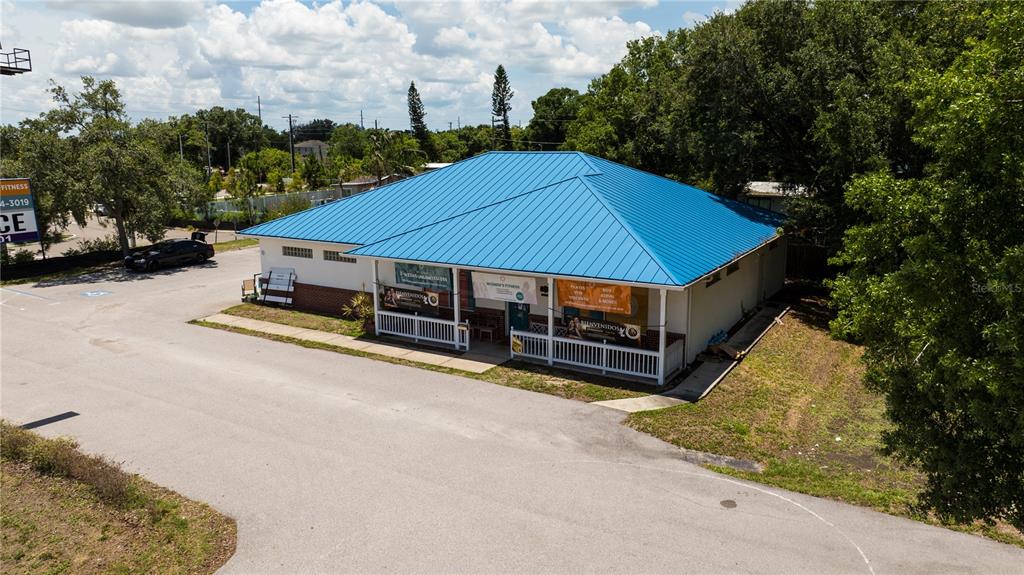 An aerial view of a single-story commercial building with a blue metal roof — 11331 US 301 HWY, RIVERVIEW, FL
