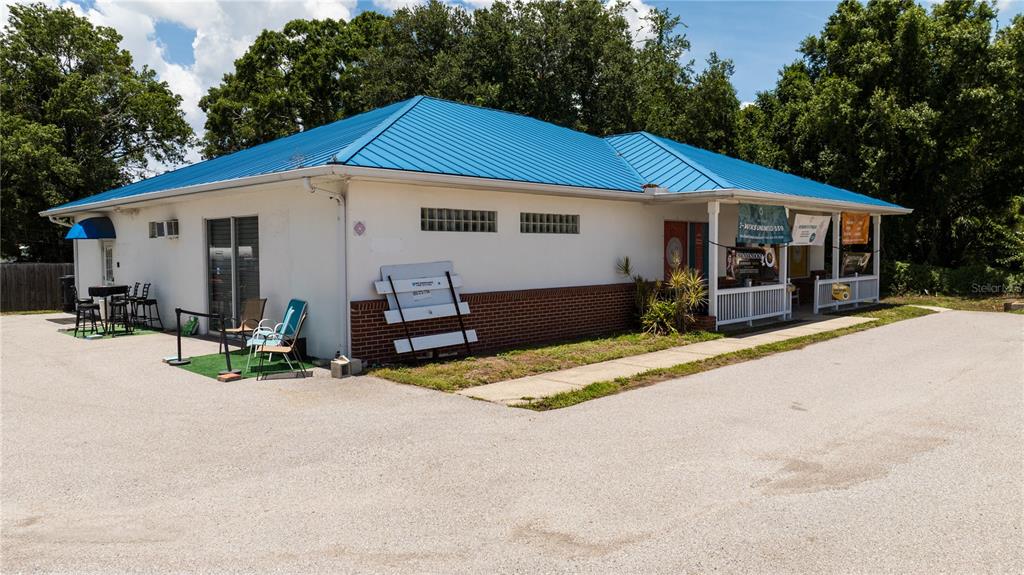A single-story commercial building with a blue metal roof and a brick-accented exterior — 11331 US 301 HWY, RIVERVIEW, FL