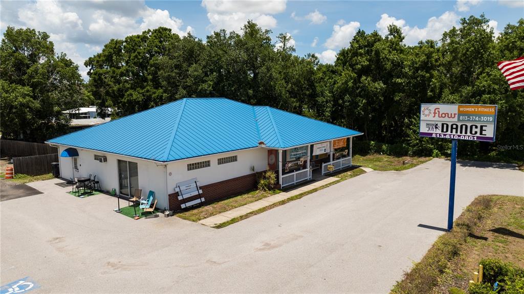 An exterior view of a single-story commercial building with a blue metal roof — 11331 US 301 HWY, RIVERVIEW, FL