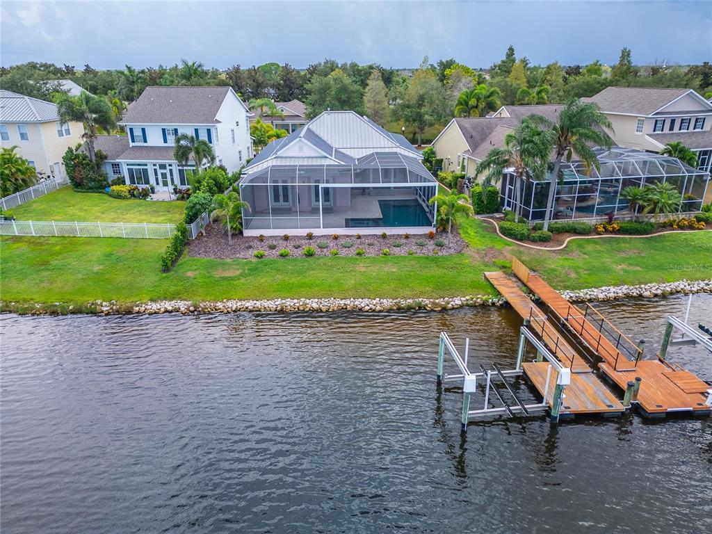 An aerial view shows a waterfront house with a screened pool and a private dock — 429 MANNS HARBOR DRIVE, APOLLO BEACH, FL