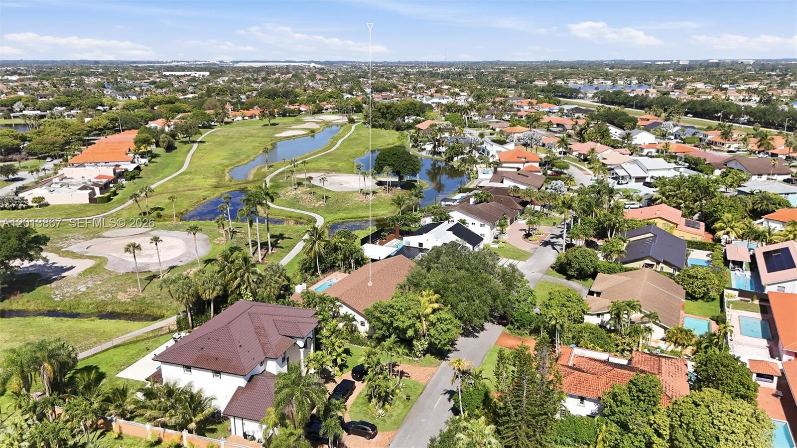 An aerial view shows a suburban neighborhood with houses, swimming pools, and a golf course — 7200 N Oakmont Dr, Hialeah FL 33015, HIALEAH, FL