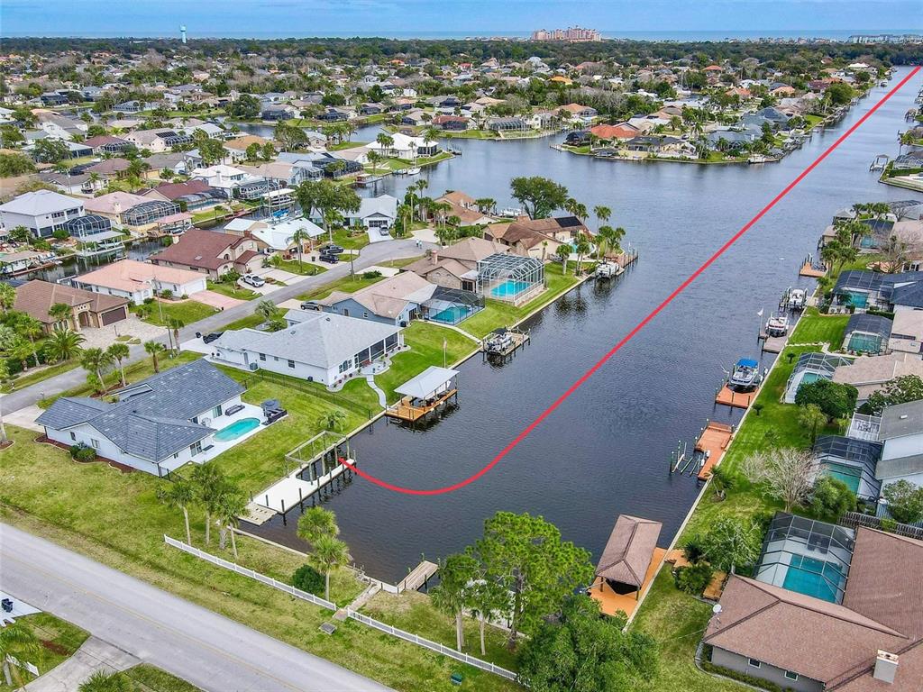 An aerial view of a waterfront residential neighborhood featuring houses with docks and swimming pools — 2 CEDAR COURT, PALM COAST, FL