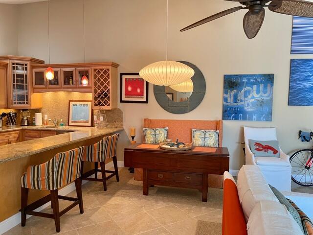 A kitchen with a breakfast bar, dining nook, and living area in an open-concept space — 1801 S Us Highway 1 # 17c, Jupiter FL 33477, JUPITER, FL