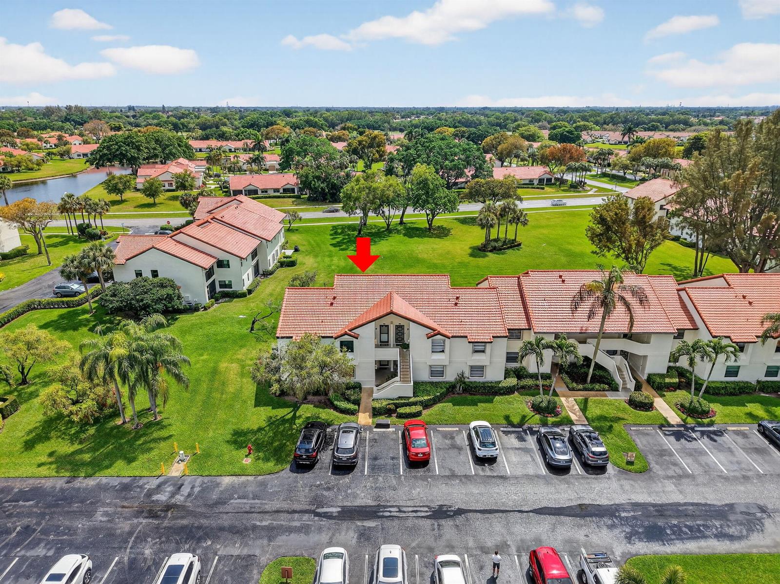 An aerial view shows a multi-story residential building with a red tile roof and parking — 6069 Parkwalk Drive, Boynton Beach FL 33472, BOYNTON BEACH, FL
