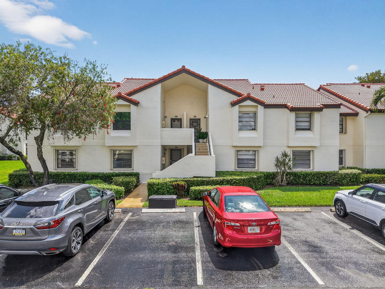 A two-story apartment building with a tiled roof and a parking lot in front — 6069 Parkwalk Drive, Boynton Beach FL 33472, BOYNTON BEACH, FL