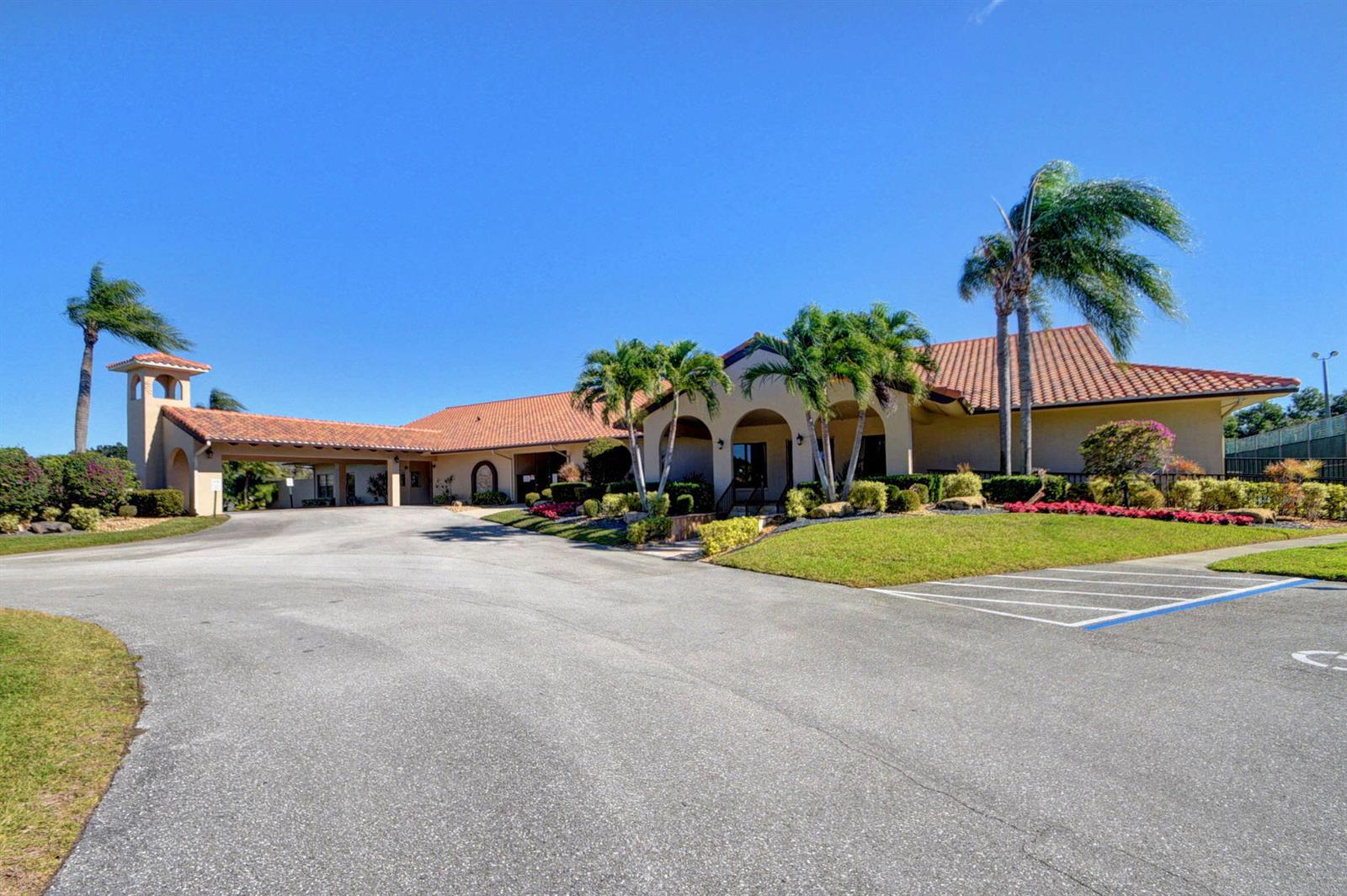 A low-rise building with a tile roof, covered entrance, and palm trees in the front — 6069 Parkwalk Drive, Boynton Beach FL 33472, BOYNTON BEACH, FL