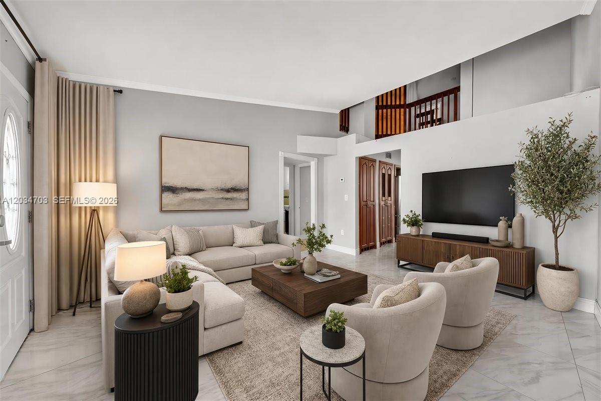 A living room features a sectional sofa, two armchairs, a coffee table, and a television — 5445 W 27th Lane, Hialeah FL 33016, HIALEAH, FL