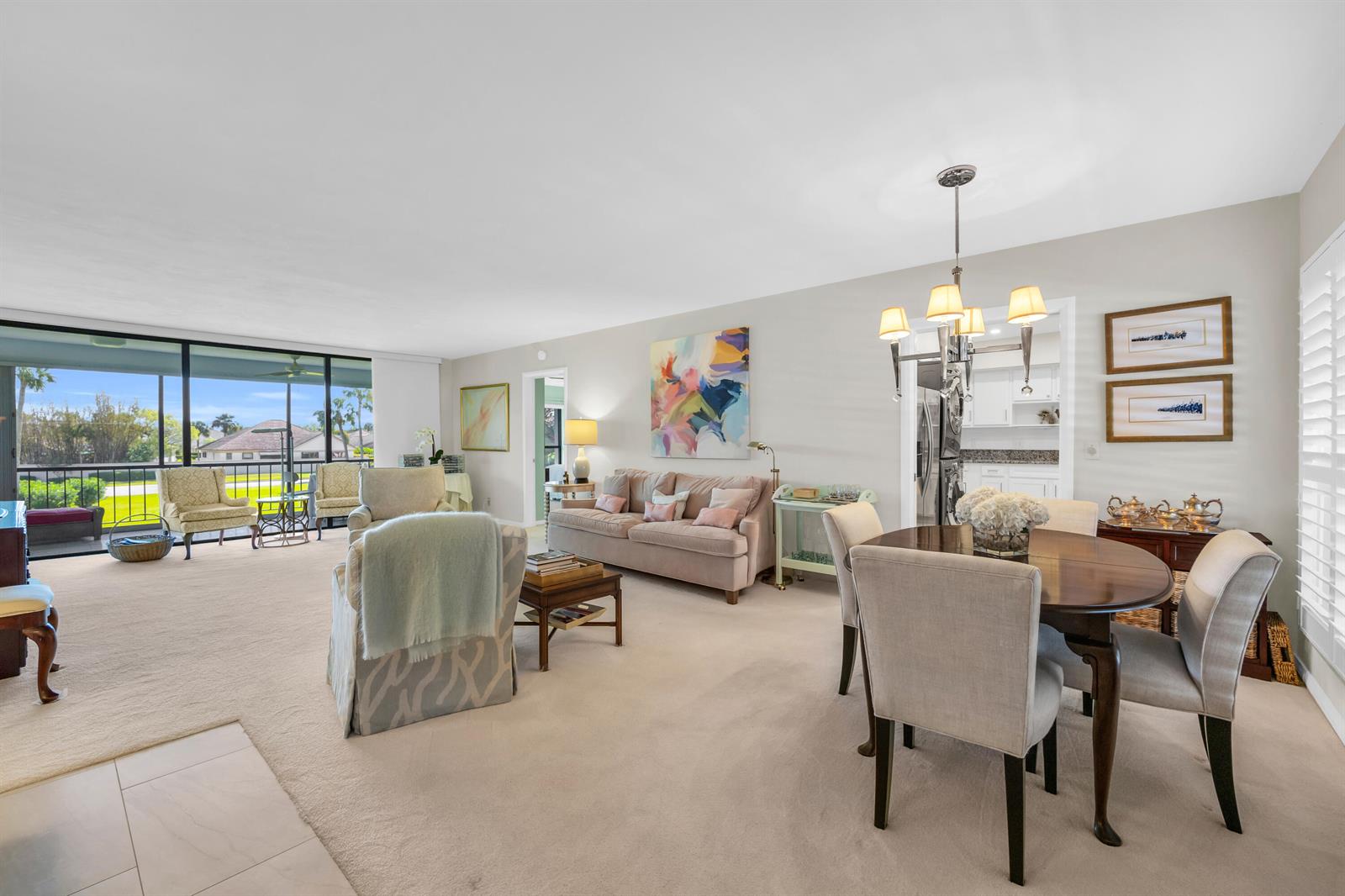 A living and dining room with beige carpet, neutral furniture, and a view of the outdoors — 4 SE Turtle Creek Drive, Jupiter FL 33469, JUPITER, FL