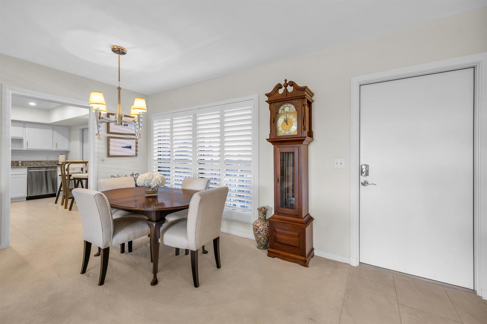 A dining area features a round wooden table, four upholstered chairs, and a grandfather clock — 4 SE Turtle Creek Drive, Jupiter FL 33469, JUPITER, FL