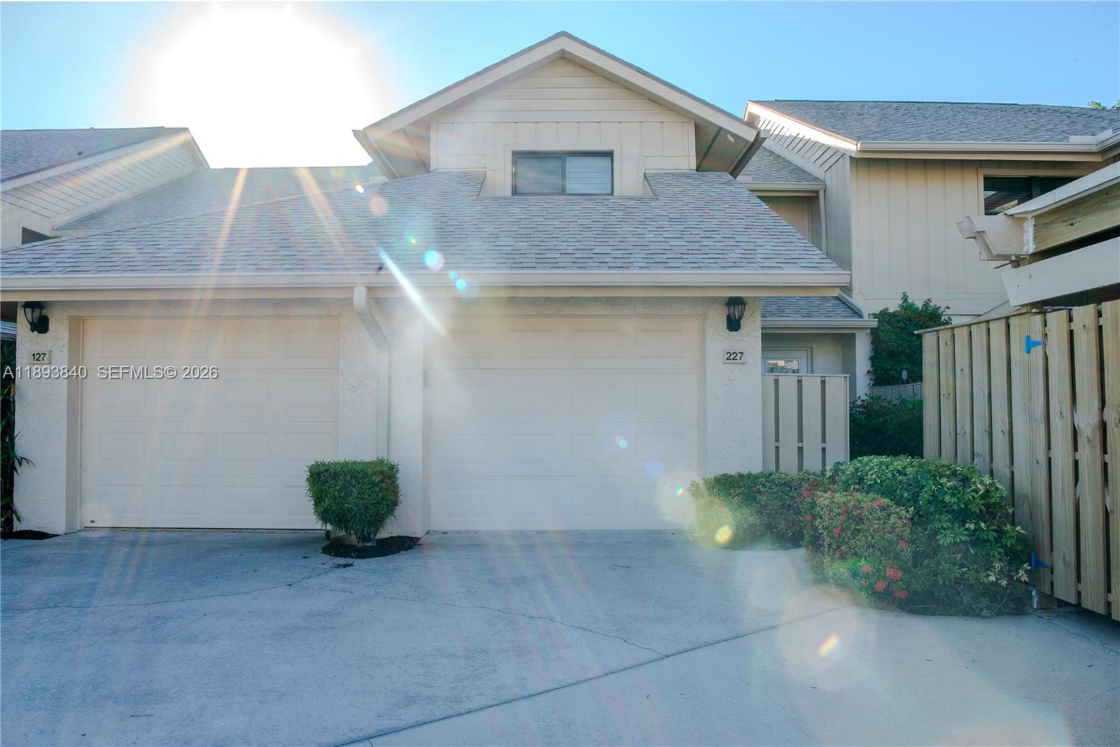 The exterior view shows two garage doors with house numbers 127 and 227 — 17081 Waterbend Dr # 227, Jupiter FL 33477, JUPITER, FL