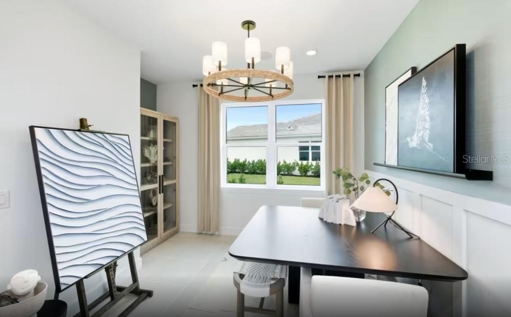 A paved walkway leads to the front entrance of a house with light gray walls — 1604 TAVIRA PLACE, ENGLEWOOD, FL