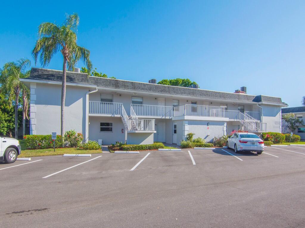 A two-story apartment building with a white exterior, balcony, and parking lot in front — 1166 6th Avenue # C5, Vero Beach FL 32960, VERO BEACH, FL