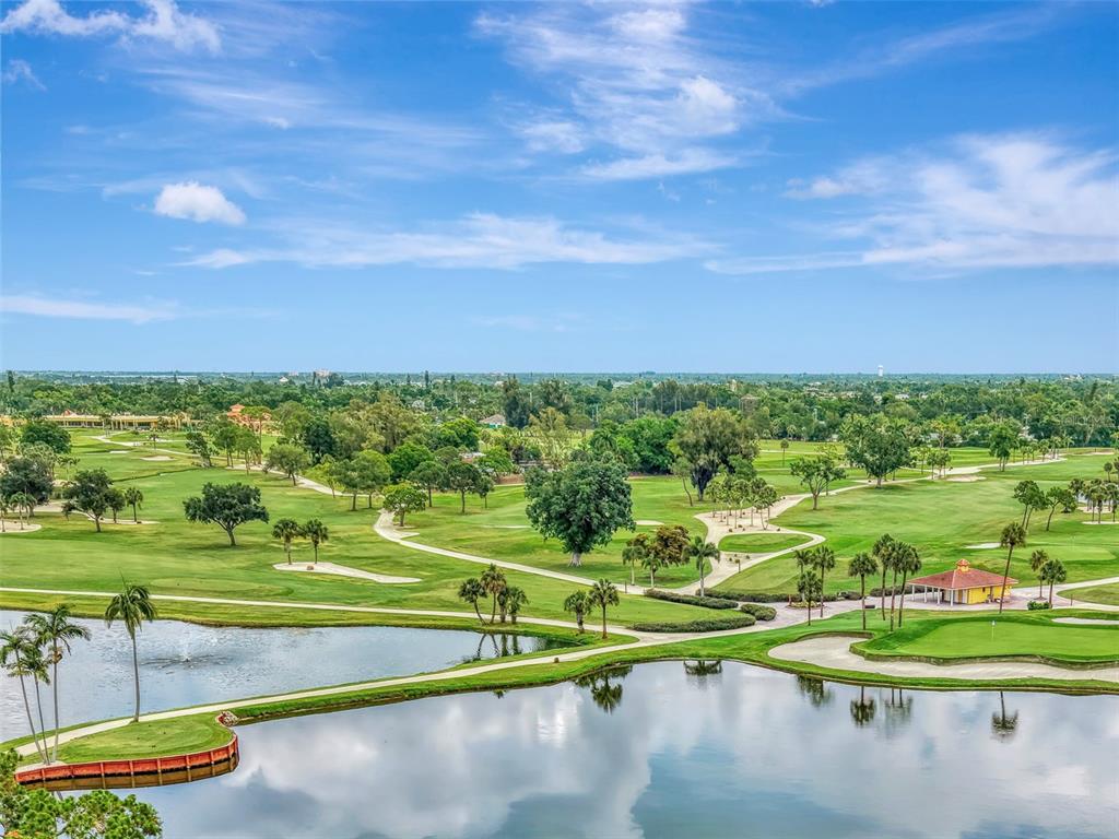 An aerial view of a golf course with a pond, walking paths, and a gazebo — 5030 18TH AVENUE W, BRADENTON, FL