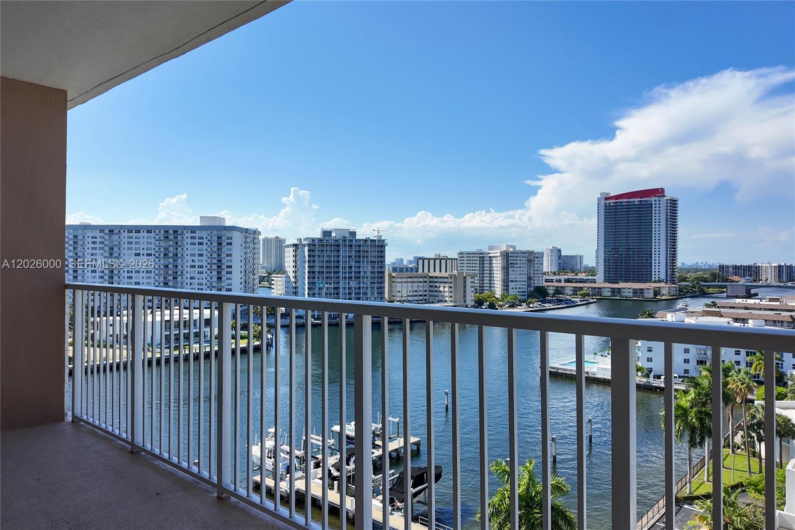 A balcony overlooks a waterway with docked boats and surrounding high-rise apartment buildings — 1965 S Ocean Dr # 9L, Hallandale Beach FL 33009, HALLANDALE BEACH, FL