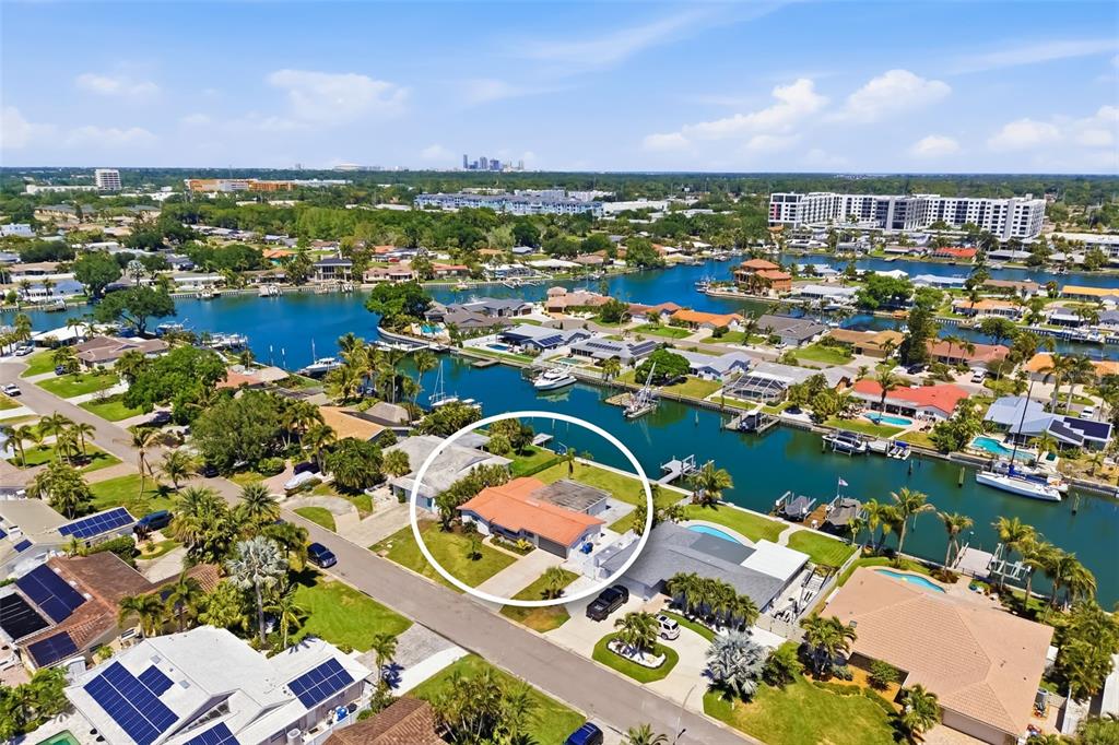 An aerial view shows a single-story house with a red roof circled in a neighborhood — 4462 39TH STREET S, ST PETERSBURG, FL