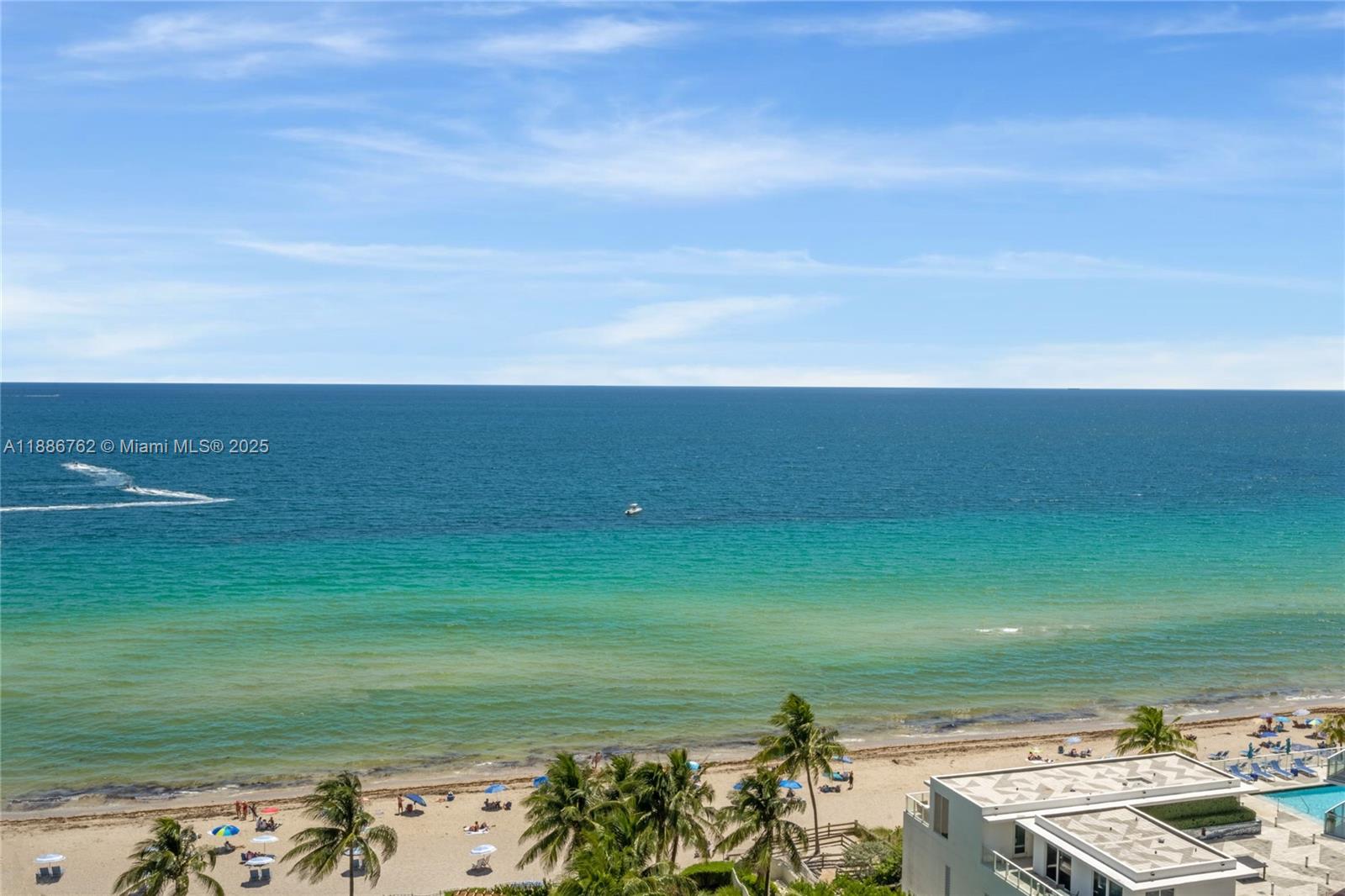 An elevated view of a sandy beach with palm trees and the ocean — 3901 S Ocean Dr # 14L, Hollywood FL 33019, HOLLYWOOD, FL