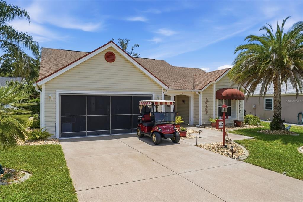 A spacious living and dining area with tile floors, a white sectional, and a hutch — 511 SAN LORENZO COURT, THE VILLAGES, FL