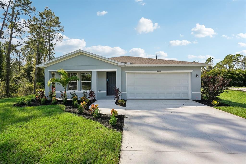 A single-story house with a gray exterior, a two-car garage, and a landscaped front yard — 2811 W REDGATE DRIVE, CITRUS SPRINGS, FL