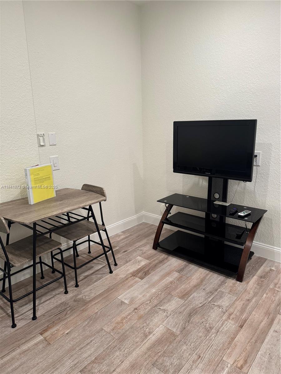 A room features light wood-look flooring, a small desk with two chairs, and a television stand — 15603 SW 178th St, Miami FL 33187, MIAMI, FL