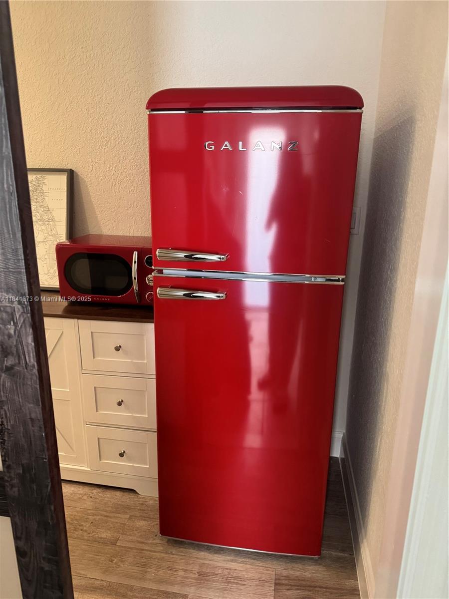 A red retro-style Galanz refrigerator and matching microwave sit next to a white cabinet — 15603 SW 178th St, Miami FL 33187, MIAMI, FL