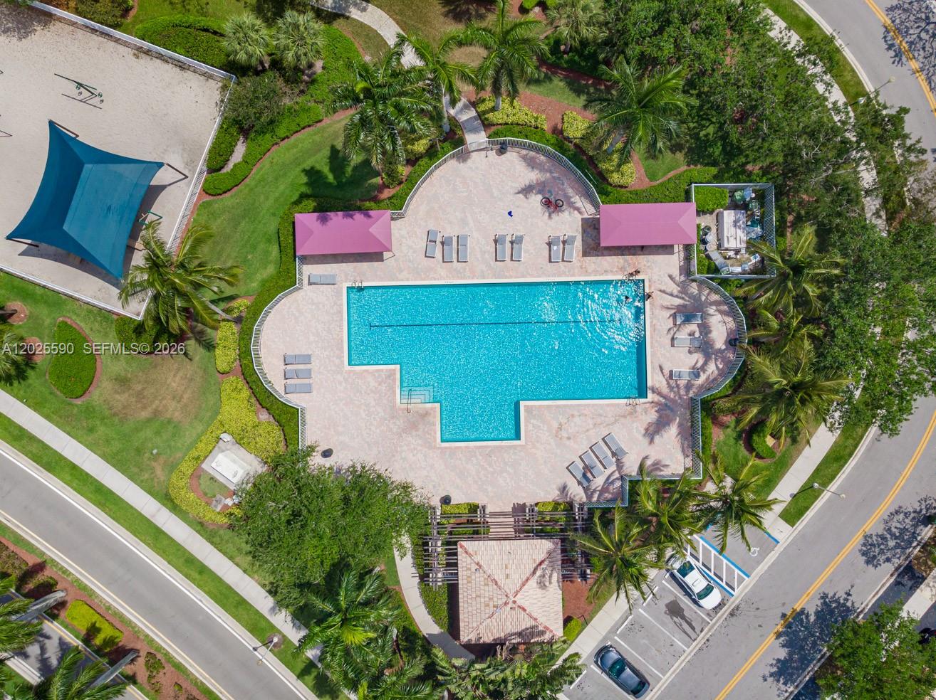 An aerial view shows a swimming pool with a deck, lounge chairs, and a gazebo — 2098 Madeira Dr, Weston FL 33327, WESTON, FL