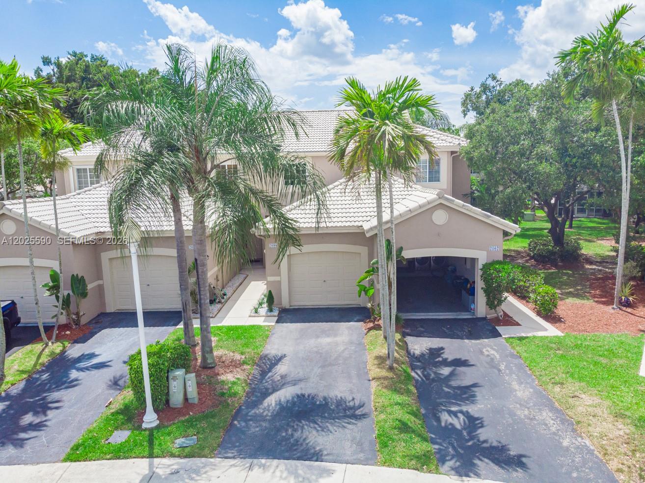 An aerial view shows a multi-unit townhouse complex with driveways, palm trees, and tiled roofs — 2098 Madeira Dr, Weston FL 33327, WESTON, FL