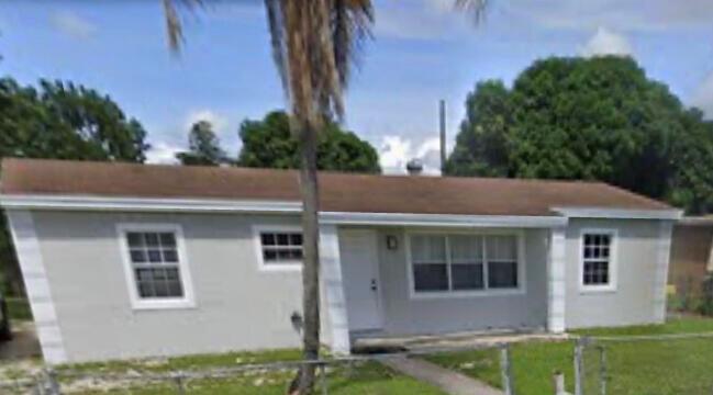 A single-story house with light gray siding, a brown roof, and a palm tree out front — 2885 NW 155th Terrace, Miami FL 33054, MIAMI, FL