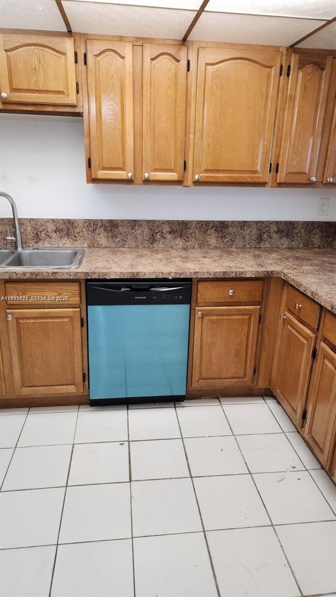 A kitchen features light wood cabinets, a brown laminate countertop, and a blue dishwasher — 10000 NW 80th Ct # 2415, Hialeah Gardens FL 33016, HIALEAH GARDENS, FL