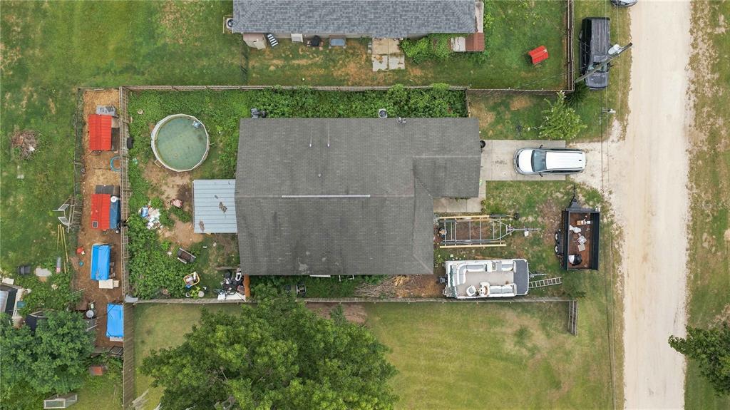 An aerial view shows a house with a pool, driveway, and various trailers in the yard — 2460 SE 69TH LANE, OCALA, FL