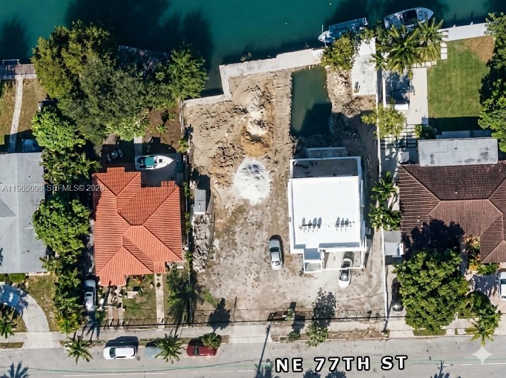 An aerial view shows a waterfront lot with a house under construction and excavation work — 531 NE 77, Miami FL 33138, MIAMI, FL