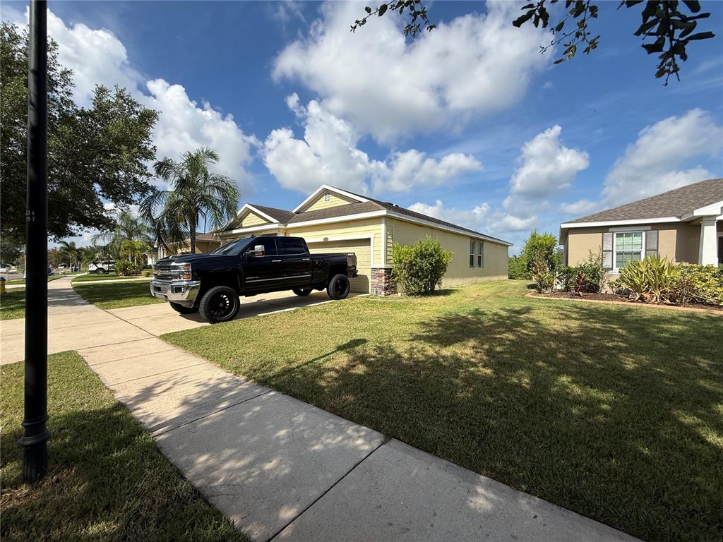 A black pickup truck is parked in the driveway of a single-story suburban house — 1751 BONITA BLUFF COURT, RUSKIN, FL