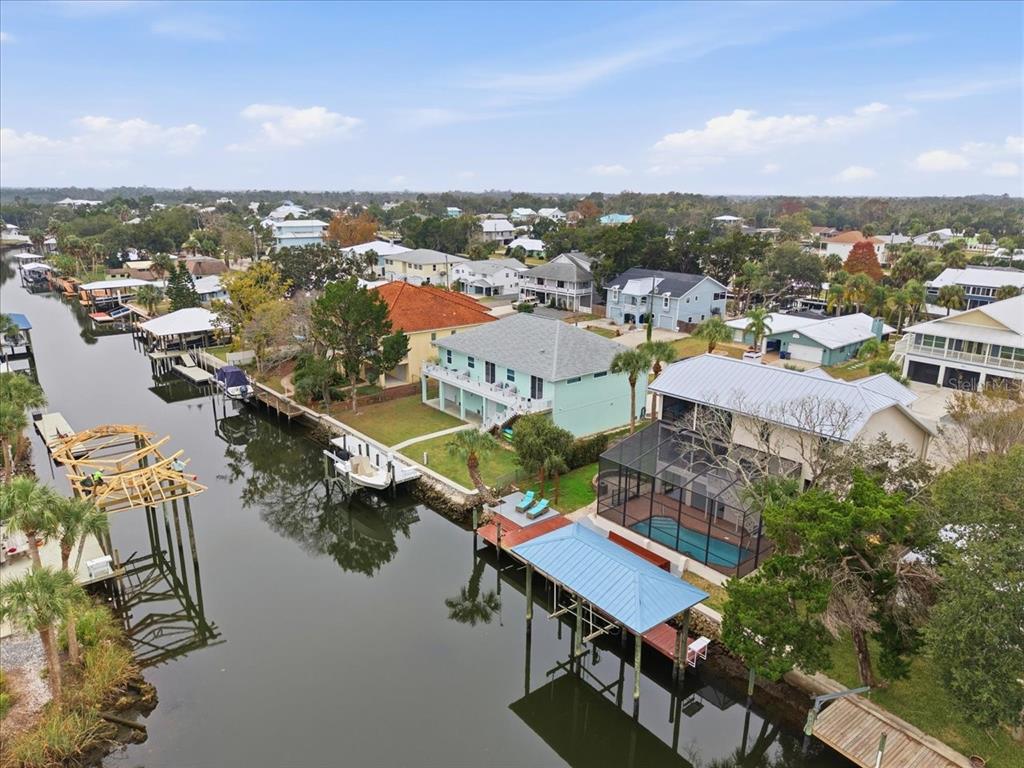 An aerial view of waterfront houses along a canal with private docks and boat lifts — 1821 NW 20TH AVENUE, CRYSTAL RIVER, FL