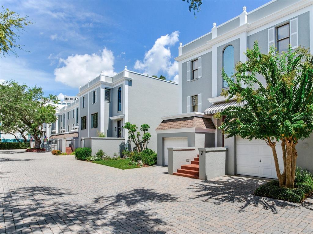 A paved driveway leads to the front entrances and garages of modern multi-story townhomes — 5010 BAYSHORE BOULEVARD UNIT 7, TAMPA, FL