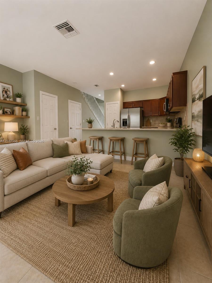 A living room with a sofa, two armchairs, and an open kitchen with bar seating — 5336 Ashley River Rd, West Palm Beach FL 33417, WEST PALM BEACH, FL
